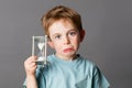 Worried young child with pouting mouth holding an egg timer Royalty Free Stock Photo