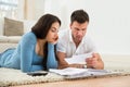 Worried young couple calculating their bills at home Royalty Free Stock Photo