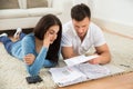 Worried young couple calculating their bills at home Royalty Free Stock Photo