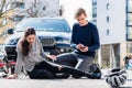 Worried young driver calling the ambulance after hitting female bicyclist