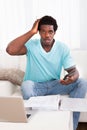 Worried Young Man Holding Calculator Royalty Free Stock Photo