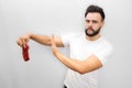 Worried young man stands and holds piece of meat. It is bad. Young man shows stop symbol with hand. He looks and poses Royalty Free Stock Photo