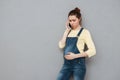 Worried young pregnant woman talking on mobile phone Royalty Free Stock Photo