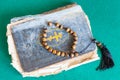 Worry beads on old psalm book on green table Royalty Free Stock Photo