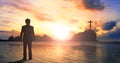 Worship and praise concept: businessman standing by the sea at sunset Royalty Free Stock Photo