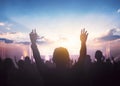 Worship and praise concept: christian people hand rising on sunset background Royalty Free Stock Photo