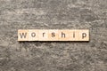 Worship word written on wood block. Worship text on cement table for your desing, concept Royalty Free Stock Photo