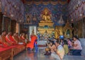 Worshipers and monks praying in Wat Kaew Korawaram Temple