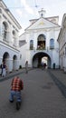 Worshipper knealing in front of Gate of Dawn in Vilnius