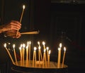 A worshipper lights candles at the Church of the Holy Sepulchre, Jerusalem Royalty Free Stock Photo
