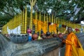 A worshipper places a clay pot next to the Sacred Bodhi Tree at Kataragama Temple in Sri Lanka.