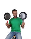 African American man holding up two freeing pan Royalty Free Stock Photo