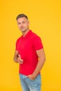 Would you like. Handsome man point finger yellow background. Promoting and marketing. Promoting menswear shop