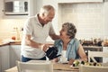 Would you like some tea. a senior couple having breakfast together at home. Royalty Free Stock Photo
