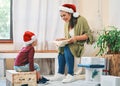 Would you like to hear the story of Christmas. a young woman reading a book with her adorable son at Christmas. Royalty Free Stock Photo