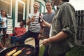 It wouldnt be a bbq without your best mates. a group of friends having a barbecue in the yard. Royalty Free Stock Photo