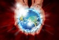 Wounded hands of Christ holding the earth Royalty Free Stock Photo