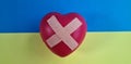 Wounded heart with band-aid and flag of Ukraine Royalty Free Stock Photo