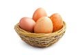 A woven basket filled with speckled eggs, isolated on a clean white background Royalty Free Stock Photo