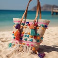 A woven beach tote bag with colorful tassel details, perfect for carrying towels and sunscreen