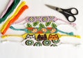 Woven DIY friendship bracelets handmade of embroidery floss with knots, alpha patterns Royalty Free Stock Photo