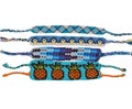 Woven friendship bracelets with blue patterns. Handmade of floss thread, isolated on white background.