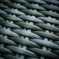 Woven wicker pattern featuring interlaced strands in shades of dark and light grey. The Royalty Free Stock Photo