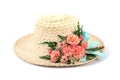 Woven woman hat with artificial rose flowers and leaves with blue ribbon isolated on white background Royalty Free Stock Photo