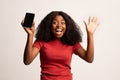 Wow. Amazed Emotional Black Lady Holding Smartphone With Blank Screen