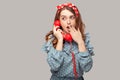 Wow! Amazed pinup girl holding phone handset surprised by conversation, covering her opened mouth shocked Royalty Free Stock Photo