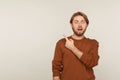 Wow, attention to advertising! Portrait of amazed shocked bearded man pointing to side copy space