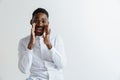 Wow. Attractive male half-length front portrait on grey studio backgroud. Young afro emotional surprised bearded man Royalty Free Stock Photo