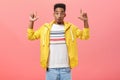 Wow awesome copy sace look. Portrait of imressed enthusiastic handsome dark-skinned guy in yellow poplin jacket folding Royalty Free Stock Photo