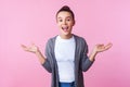 Wow awesome! Portrait of happy surprised brunette teenage girl standing with arms raised and mouth open in amazement. indoor