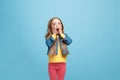 Beautiful teen girl looking suprised isolated on blue Royalty Free Stock Photo