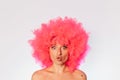 Woman wearing pink wig standing with open mouth Royalty Free Stock Photo