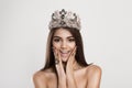 Wow. Close up portrait happy dark beauty queen young indian woman with crown beautiful girl looking excited holding her mouth Royalty Free Stock Photo