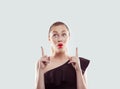 Wow. Closeup portrait young woman beautiful girl with excited holding her mouth opened, hands index fingers pointing up isolated Royalty Free Stock Photo