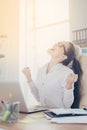 Wow! A dream of the young cute entrepreneur came true. She is very excited, wearing smart outfit, celebrating at the work place Royalty Free Stock Photo