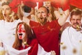 Emotive football, soccer fans from England cheering their team with white red scarfs at stadium. Concept of sport Royalty Free Stock Photo