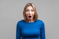 Wow, I can`t believe this! Portrait of astonished woman with stunned shocked face. indoor studio shot isolated on gray background Royalty Free Stock Photo