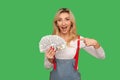 Wow, I have big money! Portrait of rich adult woman pointing at dollar banknotes and looking with amazed expression