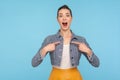Wow, I`m awesome! Portrait of excited amazed fashionably dressed woman with hair bun pointing herself with shocked face