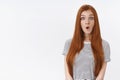 Wow impressive. Surprised amused intrigued redhead cute blue-eyed girl straight ginger hair folding lips staring amazed