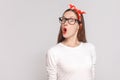 wow its unbelievable, portrait of beautiful emotional young woman in white t-shirt with freckles, black glasses, red lips and Royalty Free Stock Photo