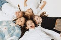 Aerial view of happy smiling school kids lying in circle and looking at camera. Beauty, kids fashion, education, happy Royalty Free Stock Photo