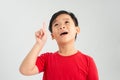 Wow look, advertise here! Portrait of amazed cute little boy with curly hair pointing to empty place on background