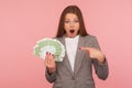 Wow look, I am rich! Portrait of millionaire, surprised woman in suit showing euro bills and staring at camera