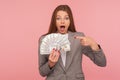 Wow look, I am rich! Portrait of surprised businesswoman in suit jacket showing dollar banknotes