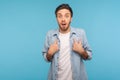 Wow, this is me! Portrait of amazed man in worker denim shirt pointing himself, looking with surprised expression Royalty Free Stock Photo